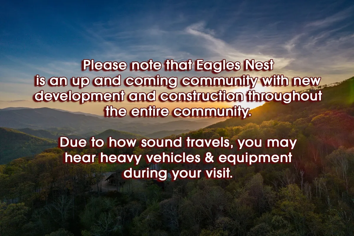 A wide view of the mountainous landscape at sunset, with lush green trees in the foreground. The scene hints at the broader community and natural attractions surrounding Storybook Cottage, inviting exploration and connection with the local area.